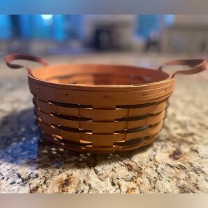 Longaberger round basket with leather handles.